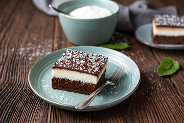 Delicious homemade dessert, fudgy coconut brownies topped with chocolate ganache glaze