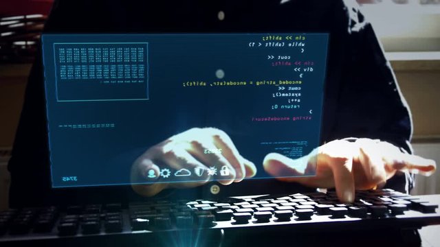 Man typing computer keyboard with program code on hologram screen. Programming, business, coding, software and cyber technology futuristic concept. Camera moves around hud display and programmer.