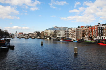 Fototapeta na wymiar View over the Amstel river on the Amstel locks in the center of Amsterdam