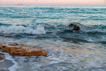 Fototapeta na wymiar sea stones rocks gulls waves sunny weather