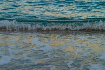 sea water with a wave tending to the shore