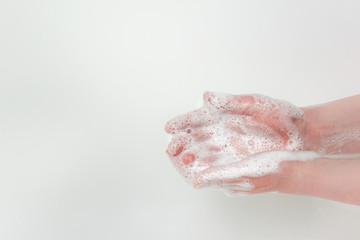 Washing hands with plenty of soap foam. Photo with copy blank space.