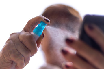 Fototapeta premium Alcohol spray to disinfect a mobile phone 