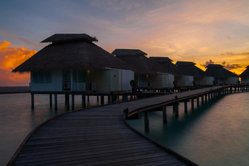 Sunset on tropical island, water villas resort