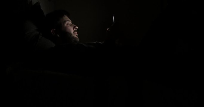 Man using the smartphone before going to sleep