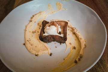 Modern homemade Spanish torrijas with vanilla ice cream on wooden background. Top view. Easter dessert.