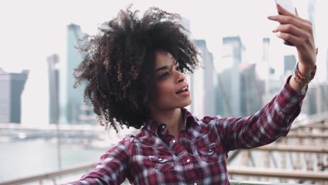 Adult Afro American female taking selfie on brooklyn bridge