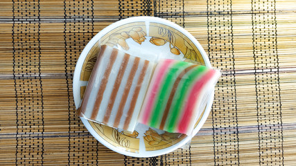 Kue Lapis, traditional food or market snacks from Indonesia, tastes sweet - with bamboo background,...