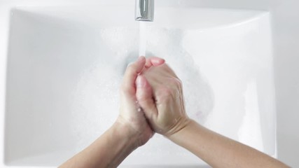 young person washing hands rubbing with soap for covid-19 epidemic prevention - Powered by Adobe