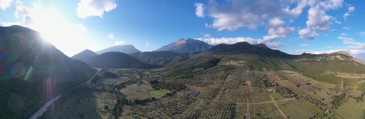 Fototapeta premium Aerial panorama of valley, morning fog over mountains, Twisting road, Tops and slopes of mountains