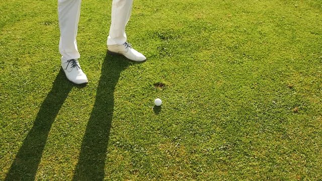 Golfer striking a ball