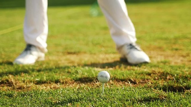 Golfer striking a ball close up