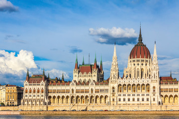Fototapeta na wymiar Building of the Hungarian National Parliament in Budapest, Hungary. Notable landmark of Hungary, and a popular tourist destination in Budapest. Designed in neo-Gothic style