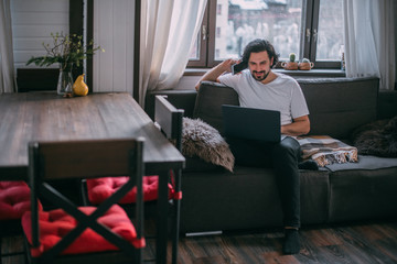 Workplace at home. A man works on a laptop at home