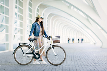 Young girl renting a bicycle to visit the city. Space for text