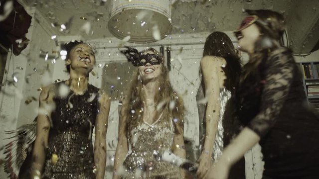 Pretty Young Adult Women dancing with confetti