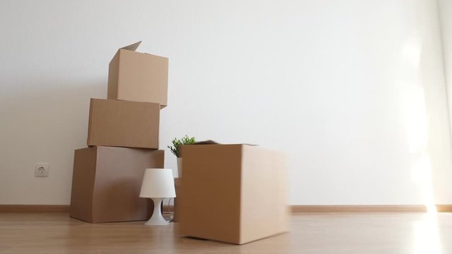 Packed household boxes for movement. Removal concept. One box glide in shot