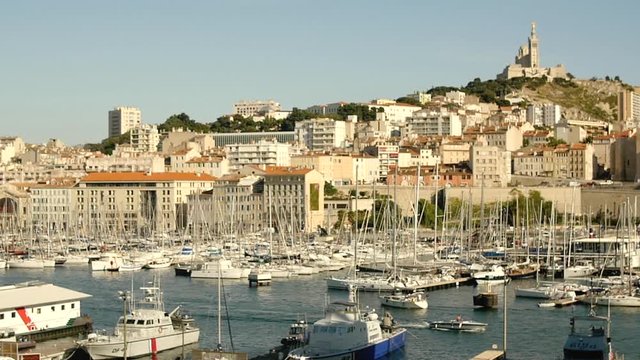 Marseille's harbor with famous Bonne M&egrave;re church in the background