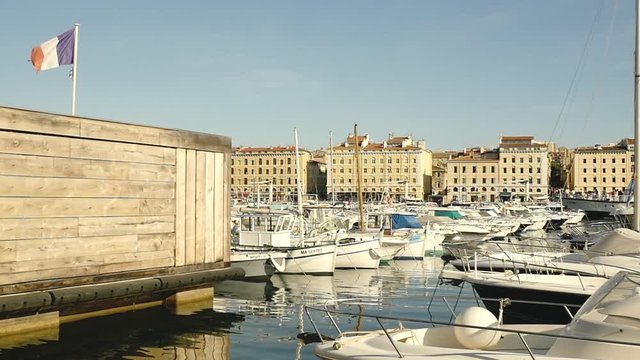 Famous Marseille's harbor with French flag in the wind