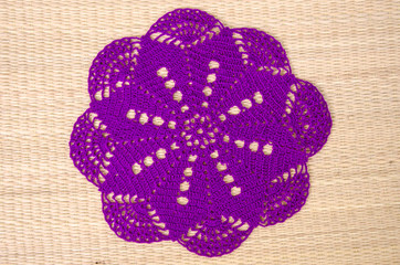 Beautiful violet clothes coasters on papyrus mat floor