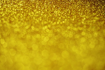 Abstract defocused shiny sparkle gold glitter bokeh background