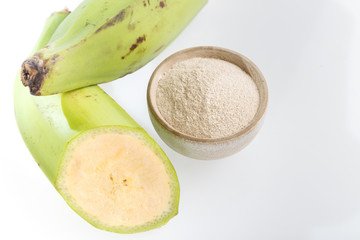 Green banana flour on white background