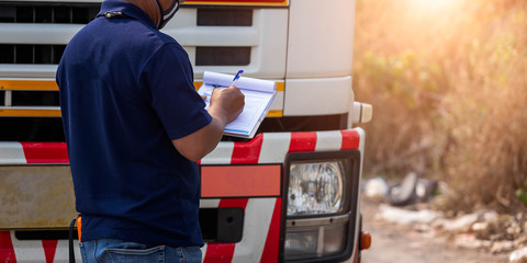 Truck drivers hand holding clipboard Check the product list,Preforming a pre-trip inspection on a...