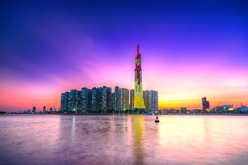 Colorful sunset landscape in a riverside urban area with skyscrapers showing the most economic...