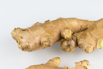 Fresh organic root ginger with slices isolated on white background. Natural anti virus medicine supports immune system