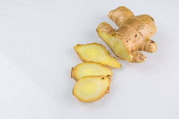 Fresh organic root ginger with slices isolated on white background. Natural anti virus medicine...
