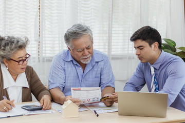 Stressed and serious retired Asian senior eldery couple consult with personal financial advisor or real estate agent about debt and expense. Retirement investment planning with professional counseling