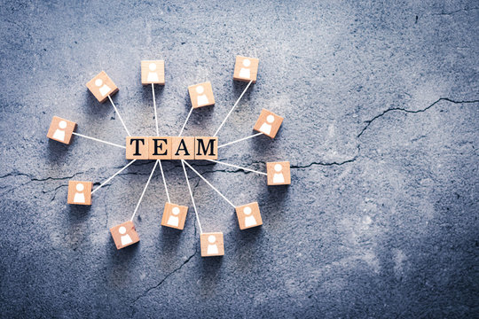Wood cube letter word of TEAM with people icon and line connection with copy space. Unity of colleague or coworkers support & work together for success. Business collaborate and partnership concept