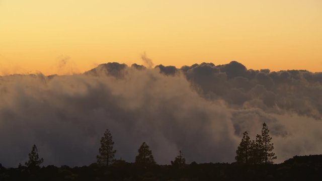 Timelapse shot of looking at clouds transformation from the mountain. Evening scene in the highland. Picturesque scene in Teide National Park on Tenerife, Canary Islands