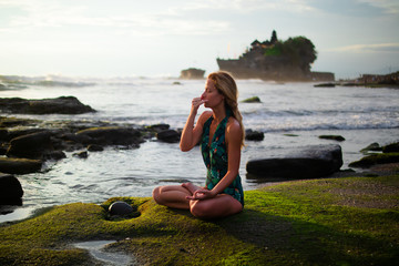 Young woman practicing Anuloma Viloma Pranayama, Alternate Nostril Breathing. Control prana through control of breath. Bali, Indonesia