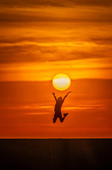 silhouette of man on sunset background of blue sky