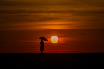 silhouette of man on the beach at sunset