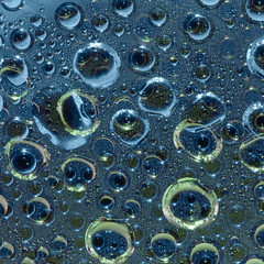 Transparent spheres and light green and blue rings and their reflections are randomly located on a...