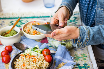 Smartphone food photography. Phone photo picture of bulgur tabbouleh with vegetables. Food order service concept for social media blogging. Vegan, vegetarian meal.