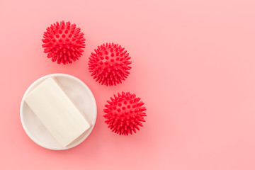 Coronavirus and soap on pink background top-down copy space