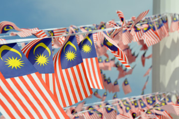 Selective focused on small size Malaysian flags tied together in large quantities. Fluttering in...
