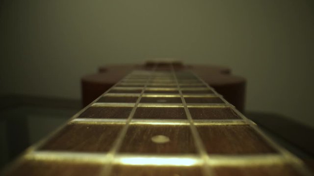 ukulele neck fingerboard close up dolly shot