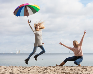 Women having fun with umbrella