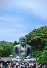 Great Buddha (Daibutsu) bronze statue of Amida Buddha and visitors and tourists at Kōtoku-in temple, Kamakura, Japan