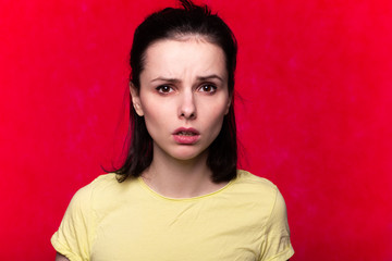 beautiful girl in a yellow t-shirt on a red background