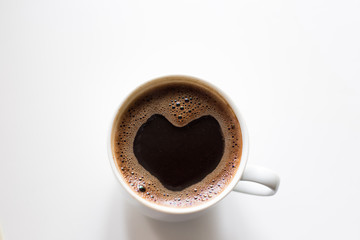 coffee in a cup, aromatic drink with foam on the surface in the shape of a heart