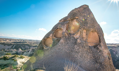 Cistern Church remains in Zemi valley with sun flare, Cappadocia. Christianity and caves in Turkey.