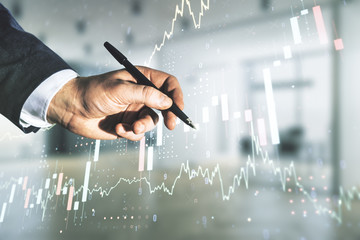 Double exposure of man hand with pen working with abstract creative financial chart hologram on blurred office background, research and strategy concept