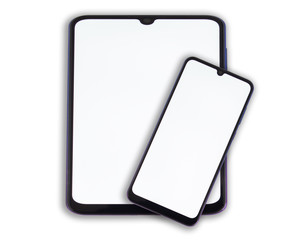 A smartphone with a white screen lies on a large tablet on a light isolated background.