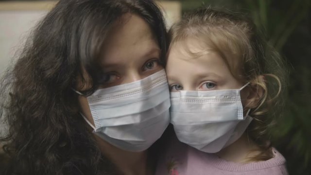 Baby with mom in a medical mask