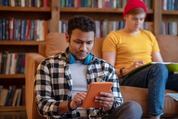 Handsome man in a checkered shirt surfing internet